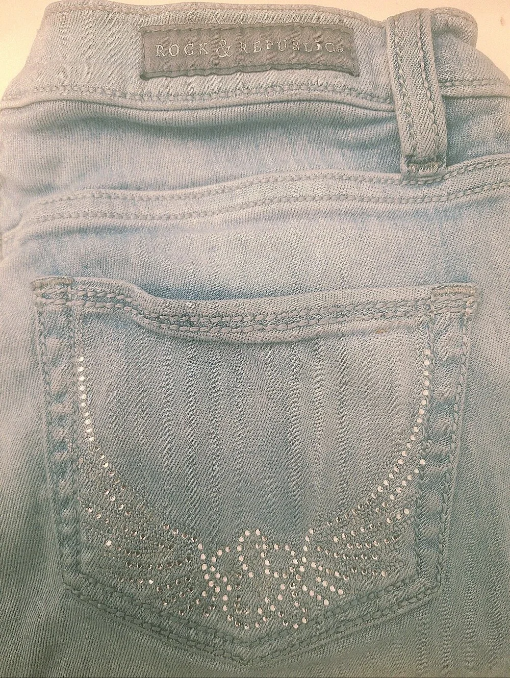 Rock & Republic Light Blue Jean Capris with Rhinestone Wing Pockets.